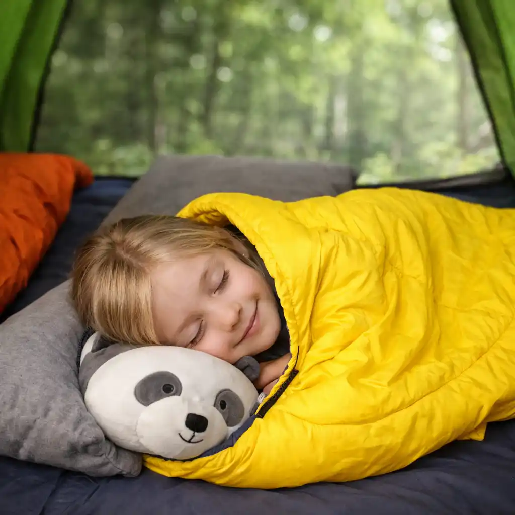 Girl sleeping in yellow kids sleeping bag inside camping tent