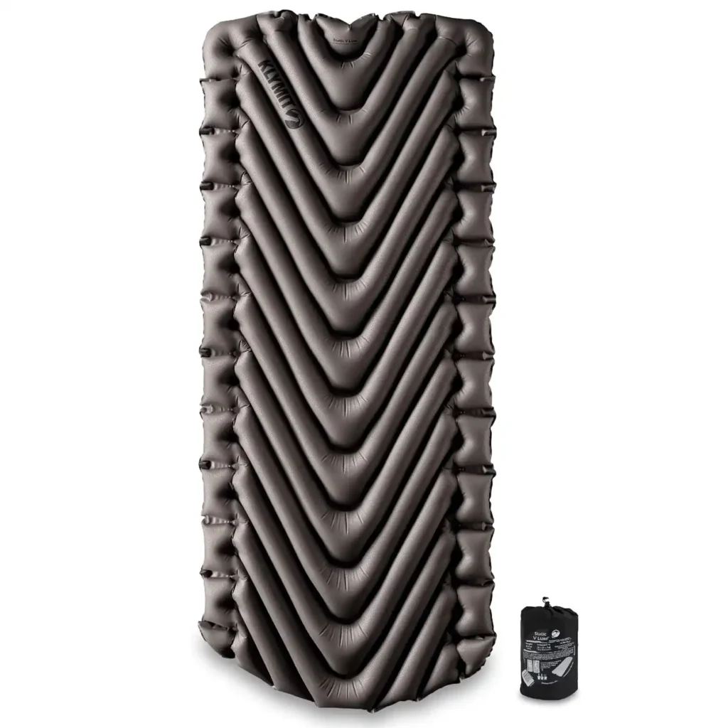 Klymit Static V Luxe Insulated sleeping pad on a tent floor, demonstrating V-shaped baffle design that improves stability and reduces slipping