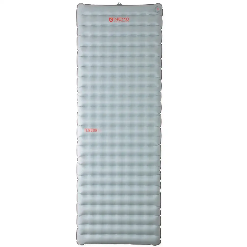 NEMO Tensor All-Season sleeping pad inside a backpacking tent, featuring a quiet, lightly textured surface that reduces pad movement