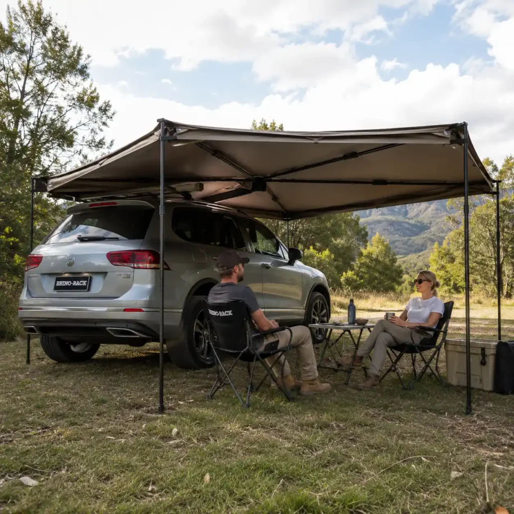 Rhino-Rack Batwing 270 Compact Awning providing spacious shade for a relaxing SUV camping and overlanding campsite.