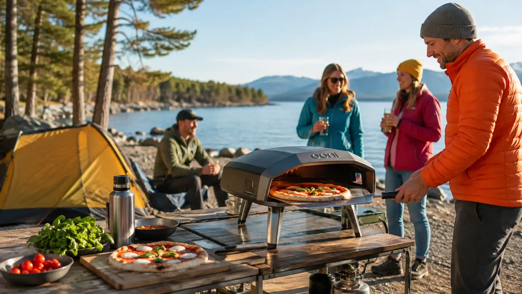 Portable camping pizza oven cooking fresh pizza at a sunny lakeside campsite with friends